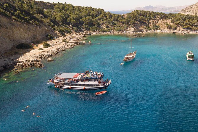 Lindos Day Cruise from Rhodes Town with Swimming stops and Hotel Transfers - Mandraki Port sights to set the tone for Lindos