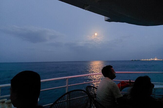 Rhodes Sunset Cruise - Swim and Dine w/ Live Music & Sunset! - Passing Saint Nicholas, the Colossus port entrance, and the lit walls
